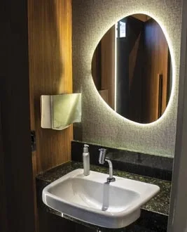 Illuminated round mirror and wall-mounted basin