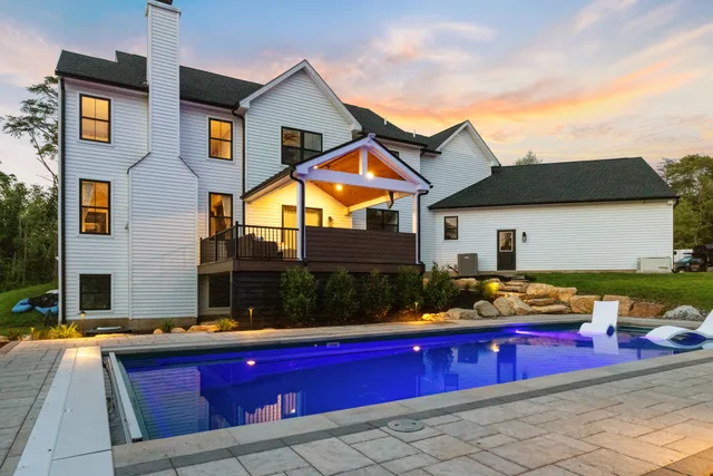 Kennedy Design + Build pool, patio and pavilion at dusk